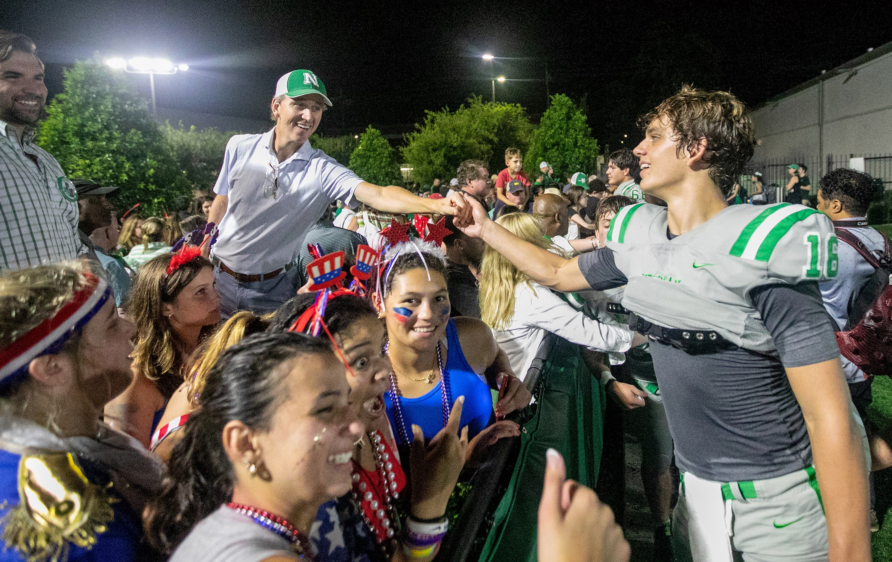 Arch Manning gets a congratulatory shake from his father Cooper Manning after Newman High...