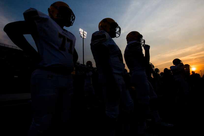 Arlington Lamar High School football players watch their game against Richland High School...