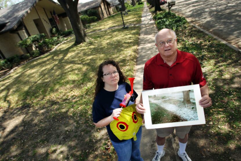 Allyson Baughn displays her weaponry to prevent egrets from nesting in Chamberlain Drive...