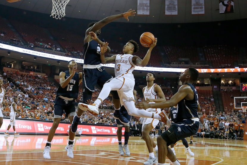 AUSTIN, TX - NOVEMBER 14: Jacob Young #3 of the Texas Longhorns leaps to the basket against...
