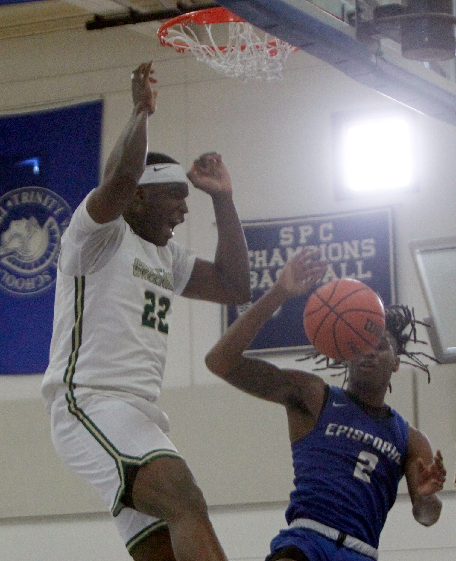 Greenhill's Lee Dort (22) reacts after a dunk against Houston Episcopal's Jakeel Registe (2)...