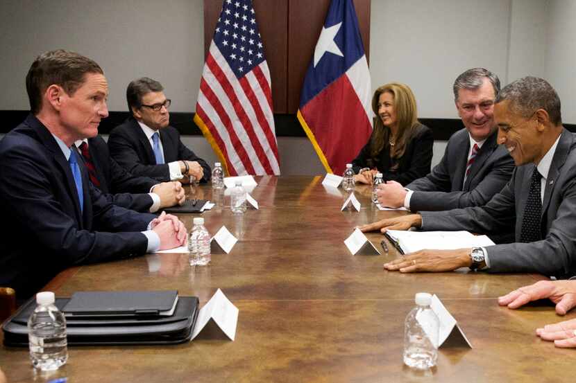  President Barack Obama, right, next to Dallas Mayor Mike Rawlings attends a meeting about...