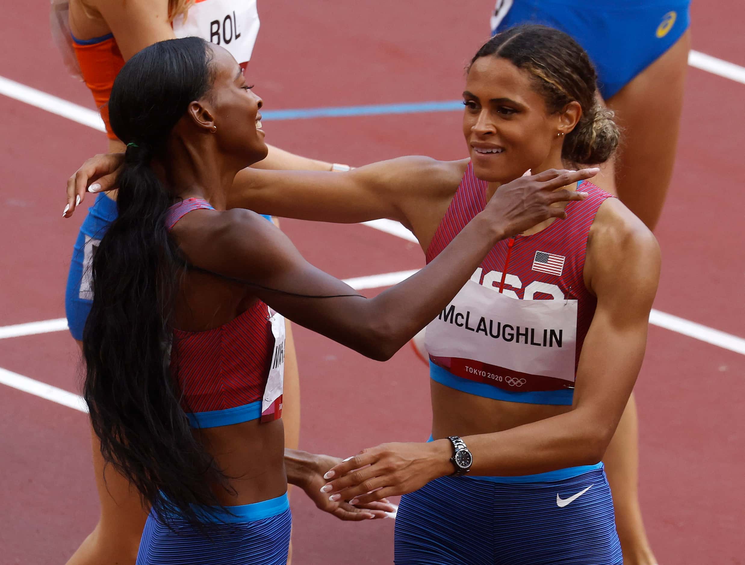 USA’s Sydney McLaughlin hugs USA’s Dalilah Muhammad after they finished first and second in...