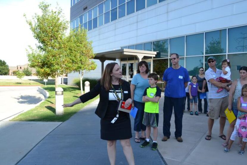 
Headmaster Holly Mohler (center) discusses how student drop-off and pick-up will flow when...