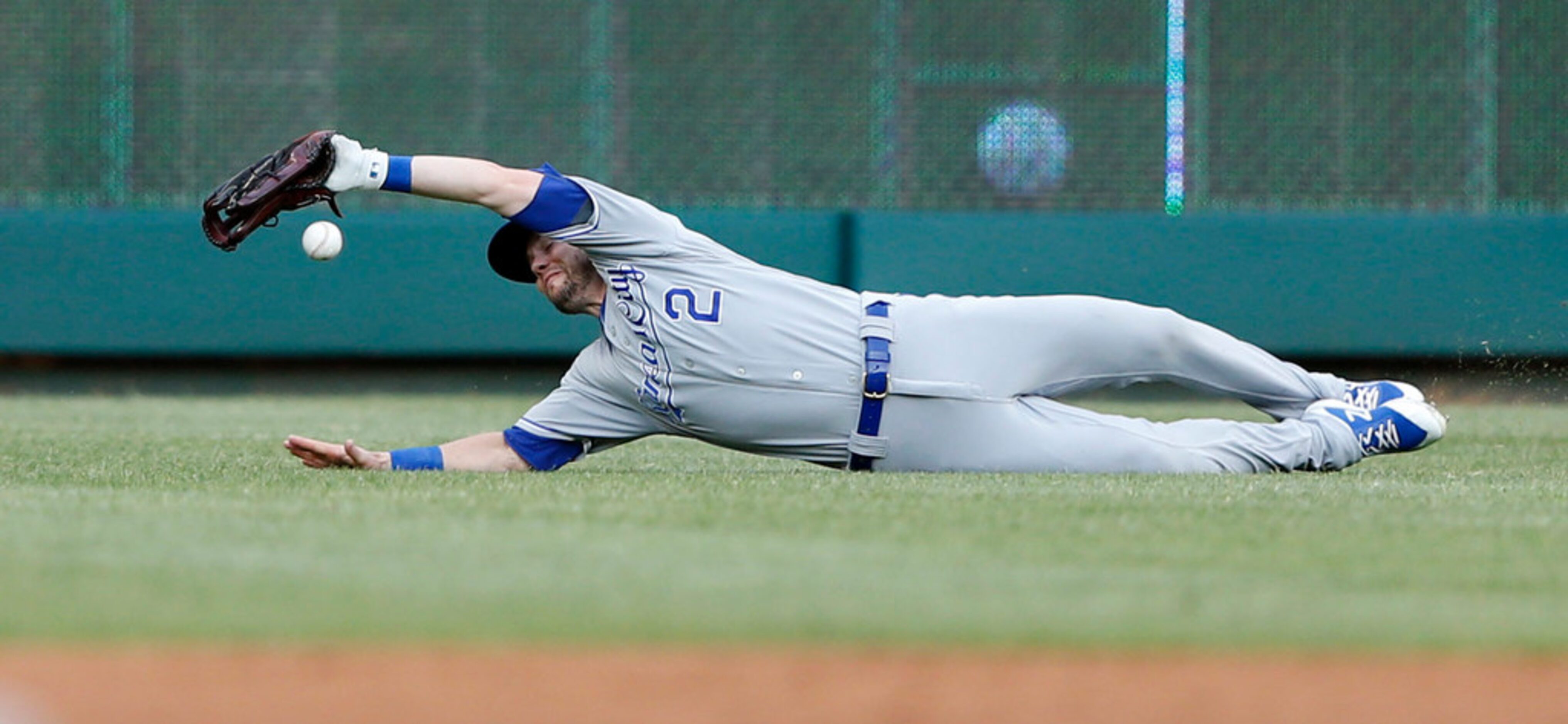 Kansas City Royals second baseman Chris Owings (2) dives for a ball hit by Texas Rangers...