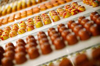 Passion Fruit (center) and other flavors of chocolate bonbons are pictured in a display case...