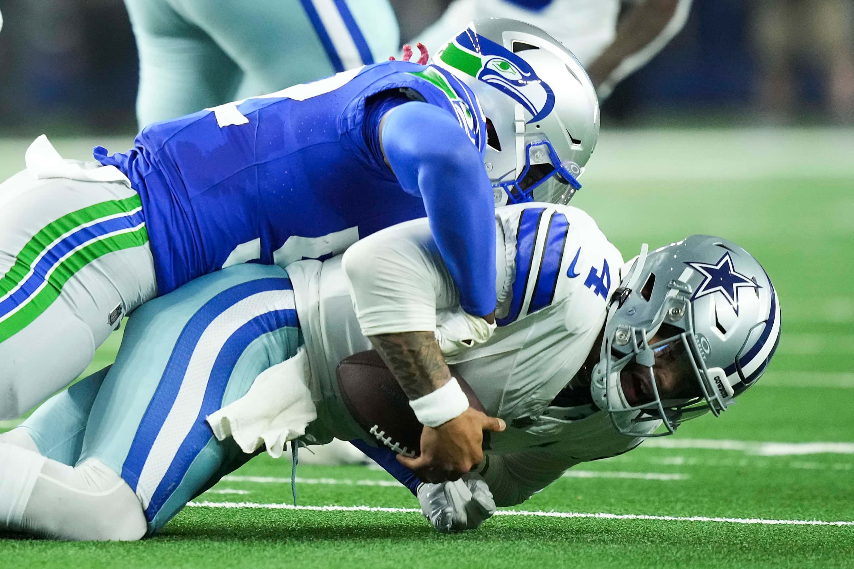 Dallas Cowboys quarterback Dak Prescott (4) is sacked by Seattle Seahawks linebacker Darrell...