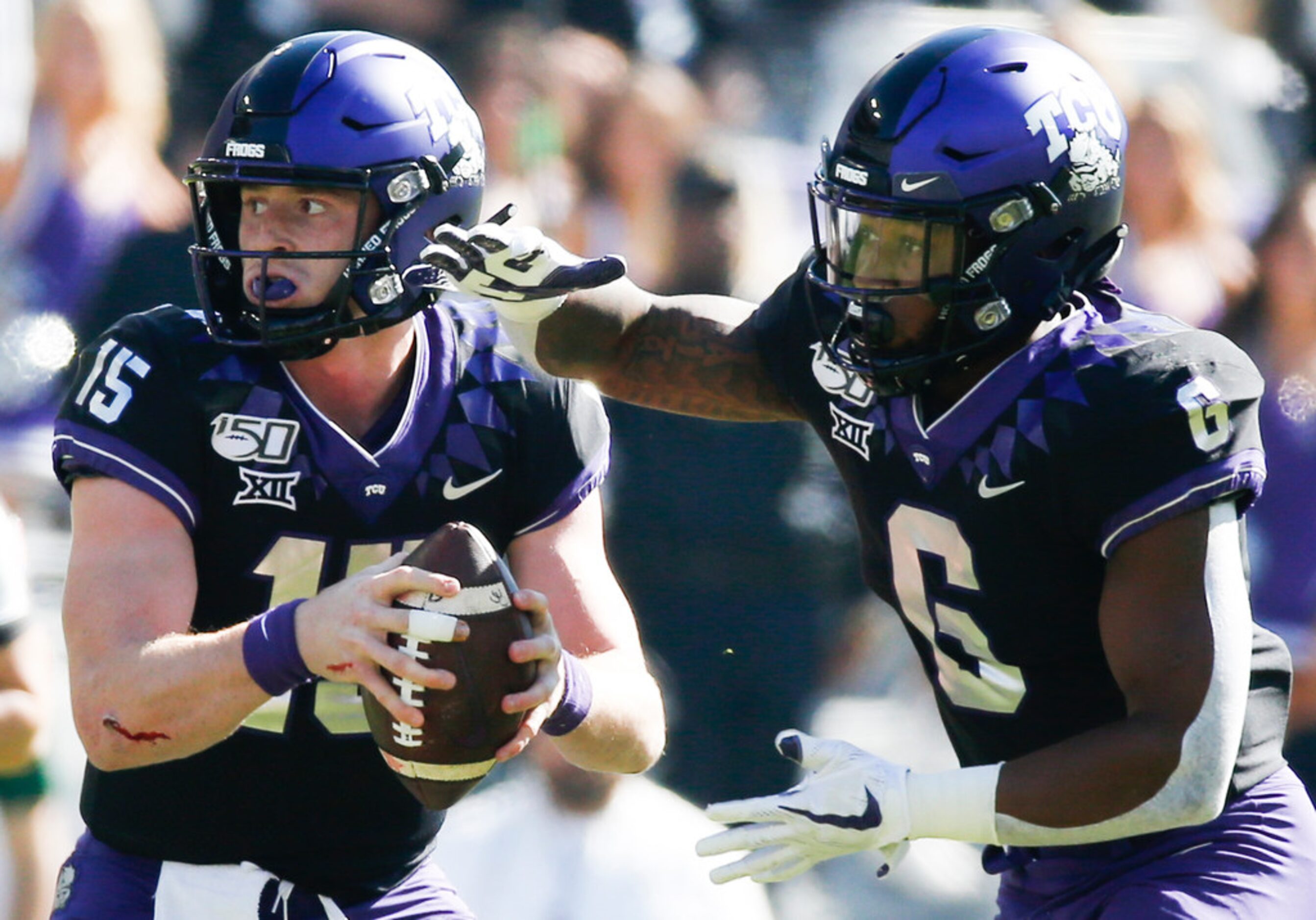 TCU Horned Frogs quarterback Max Duggan (15) hands off to TCU Horned Frogs running back...