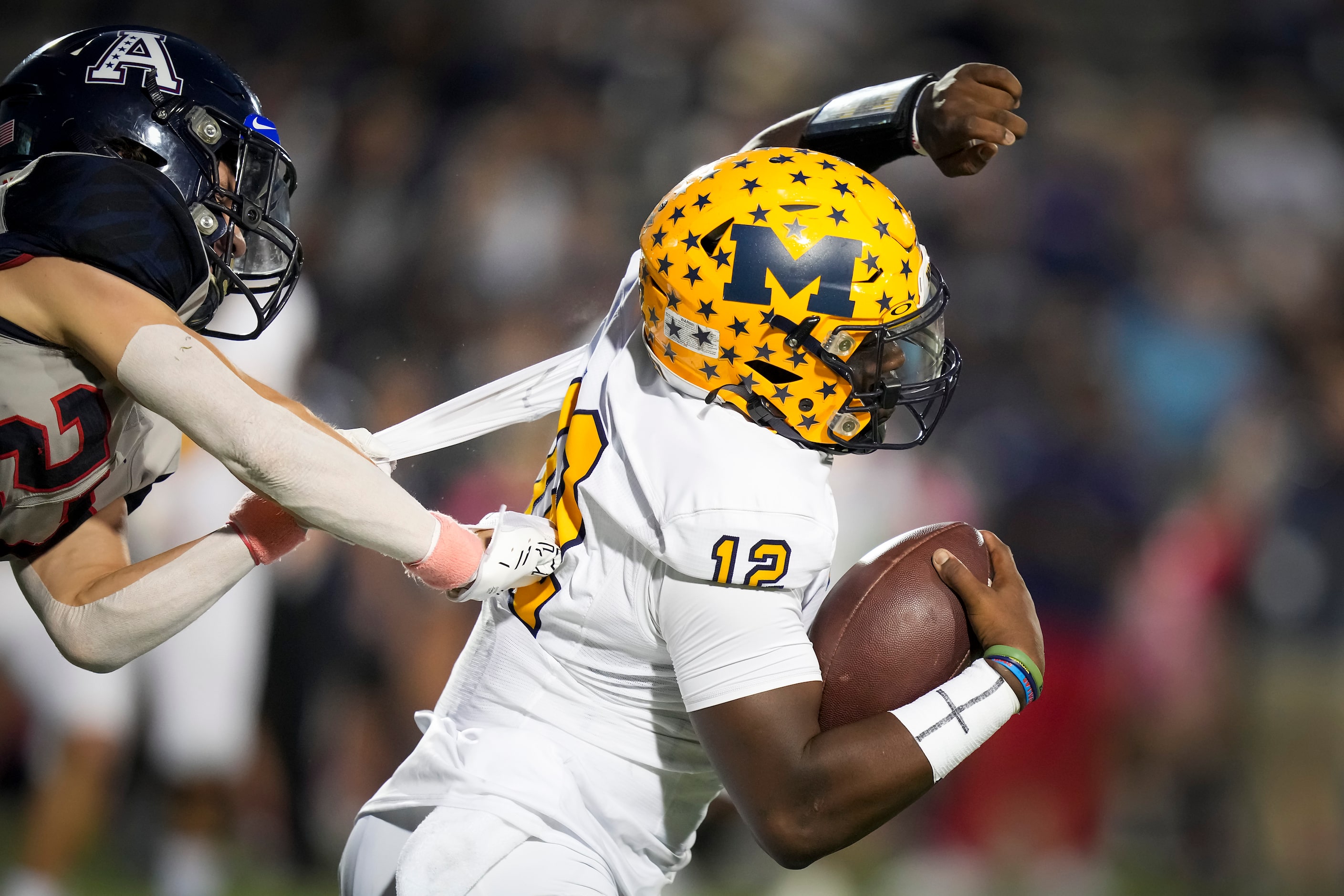 McKinney quarterback Keldric Luster (12) scrambles away from Allen cornerback Emery Lasseter...