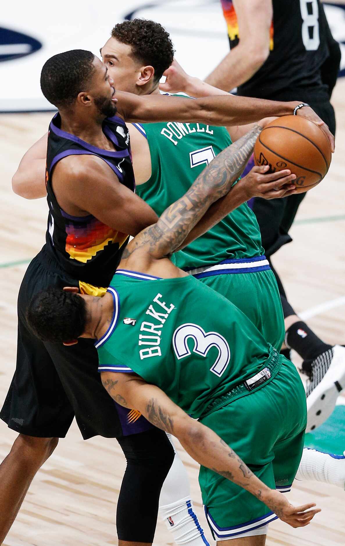 Dallas Mavericks guard Trey Burke (3) battles Phoenix Suns forward Mikal Bridges, center,...