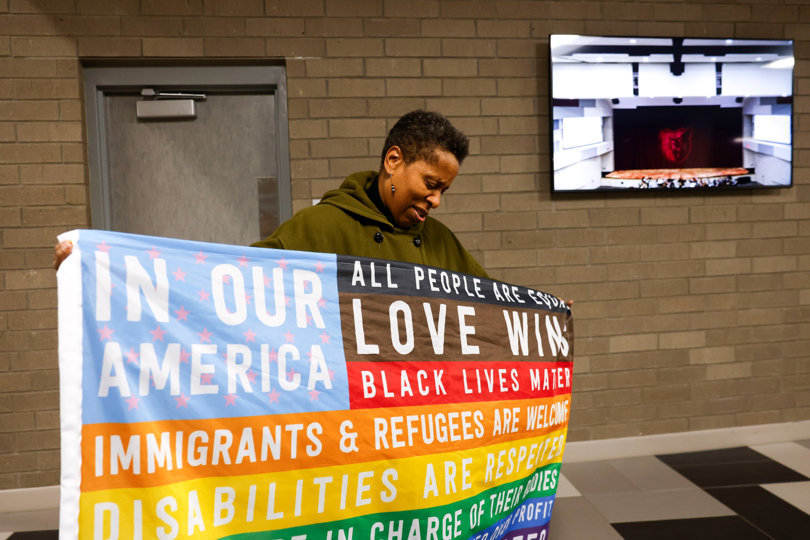 Austin College professor Lisa M. Brown shows a flag in support of the LGBTQ+ community as...