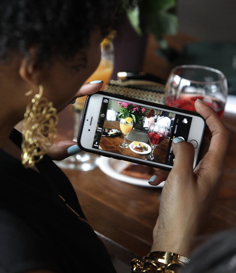 Instagramming is totally allowed at Savor Dallas. (Here, Angela West takes a photo during...