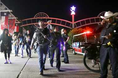 Dallas Police officers work near the scene of a shooting at the State Fair of Texas on...