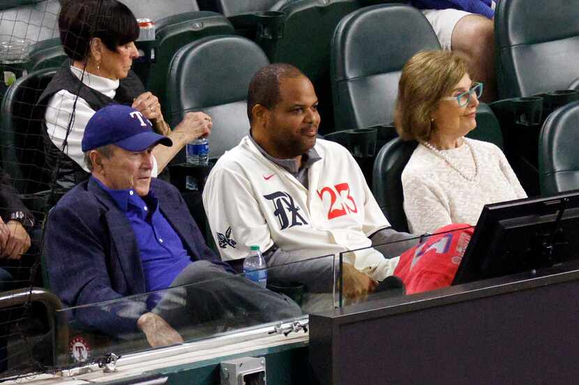 Former President George W. Bush (left) sits with Dallas Mayor Eric Johnson (center) and...