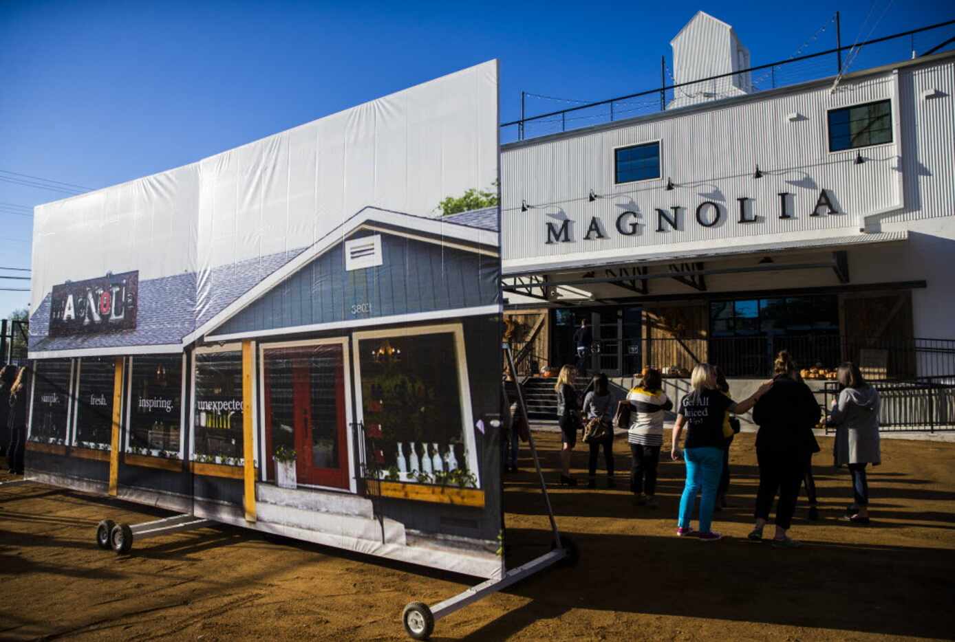 A large photo of the original store location stands outside the new location of Magnolia...