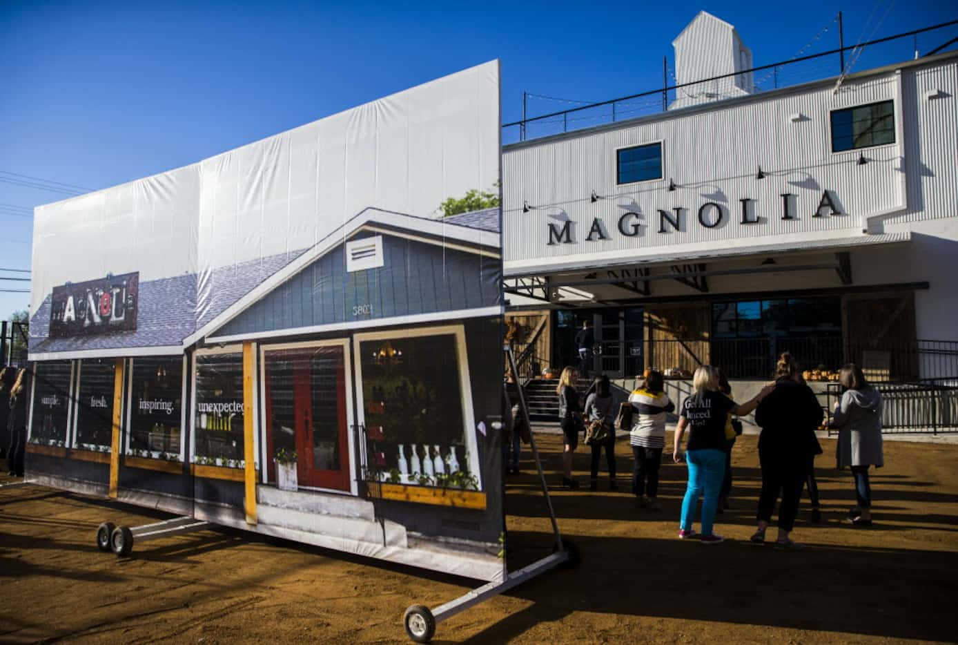 A large photo of the original store location stands outside the new location of Magnolia...