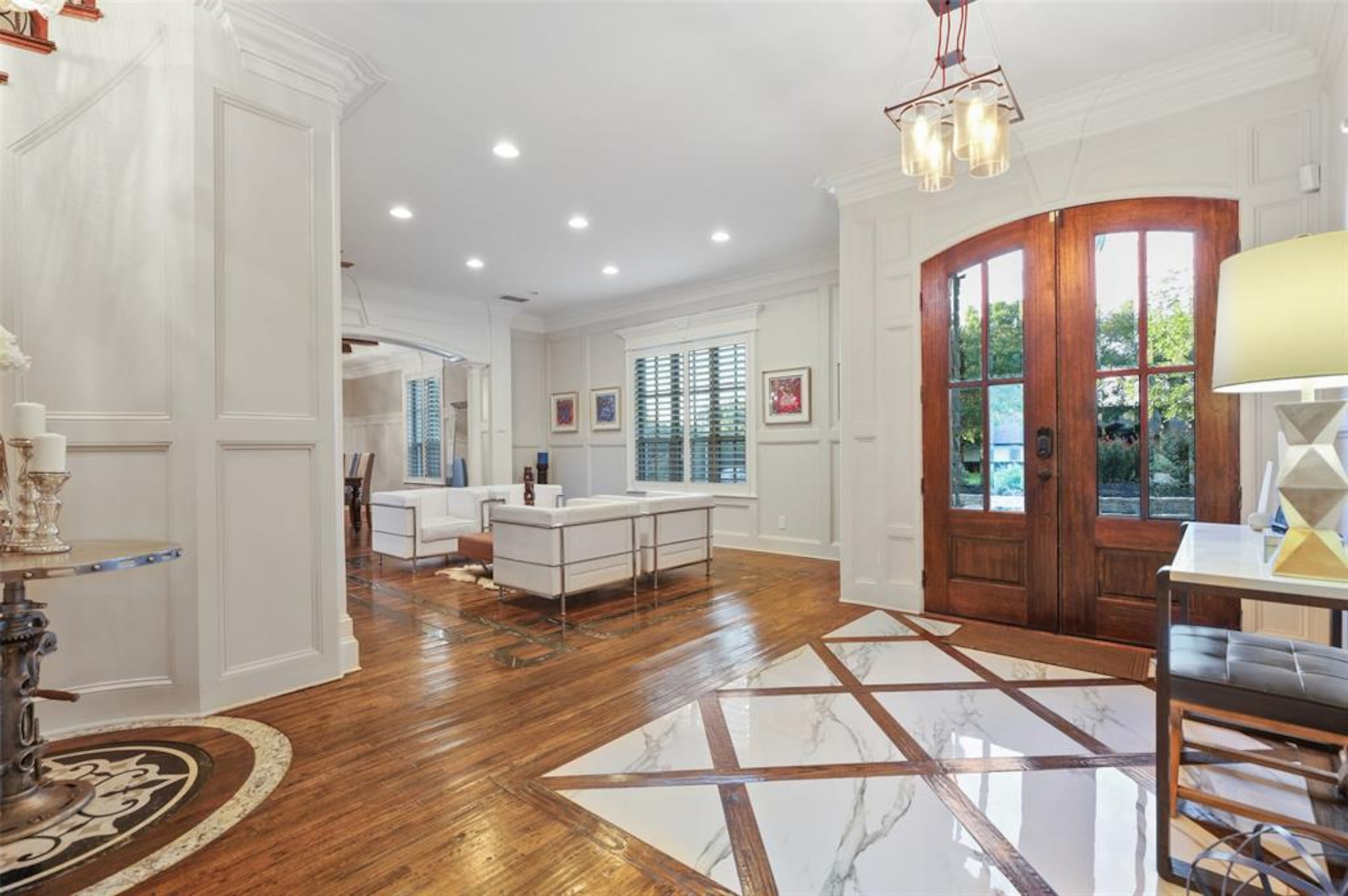 Larger foyer featured marble and hardwood floors.