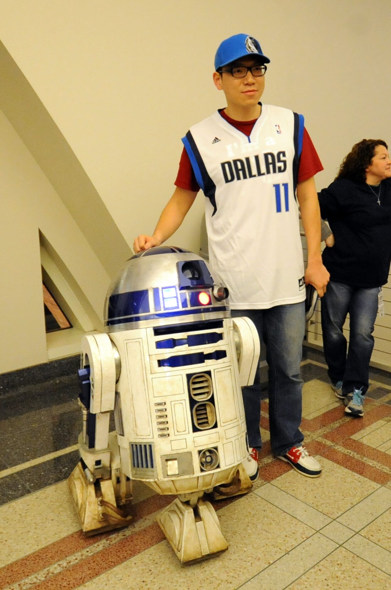 A Star Wars fan meets R2-D2 at Star Wars night at the Dallas Mavericks basketball game at...