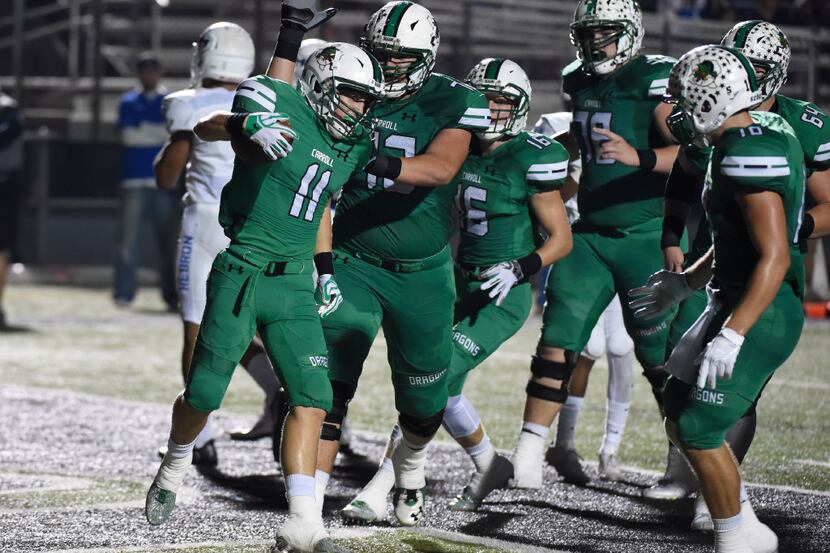 Southlake's Jackson Davis (11) is congratulated by Jackson Kimble (72) and teammates after...