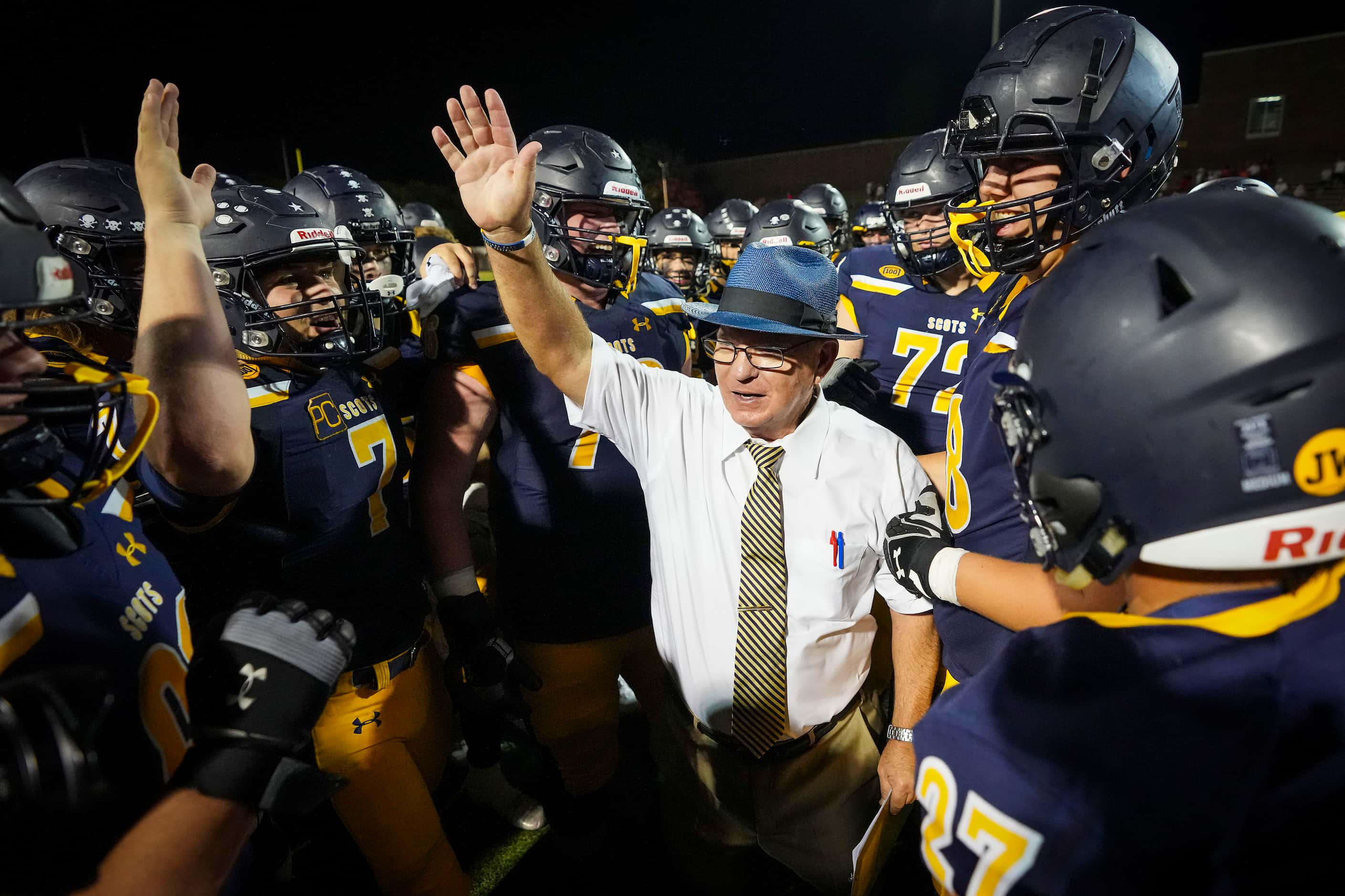 Highland Park head coach Randy Allen celebrates with his players after a victory over Lake...