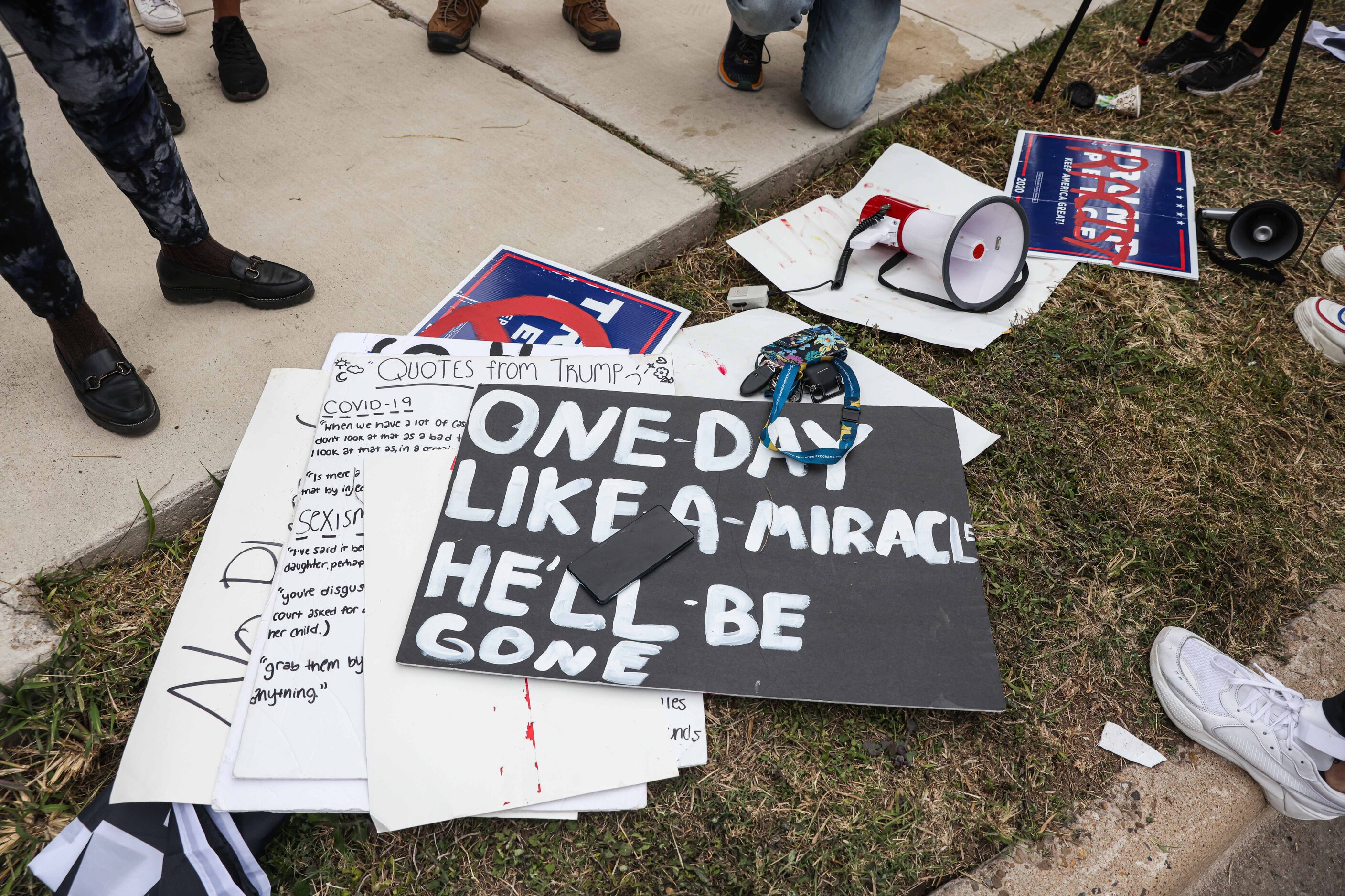 Posters in support of President-elect Joe Biden rest on the ground at S 10th St and Bales Rd...