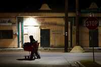 Earl, a man experiencing homelessness, pushes a cart in the 1500 block of Pennsylvania...