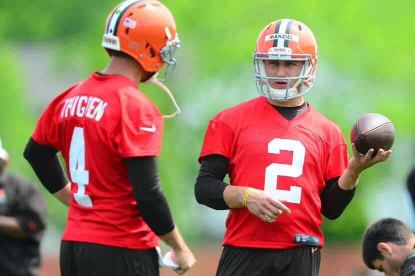 Cleveland Browns quarterback Johnny Manziel (2) talks to Tyler Thigpen (4) during organized...
