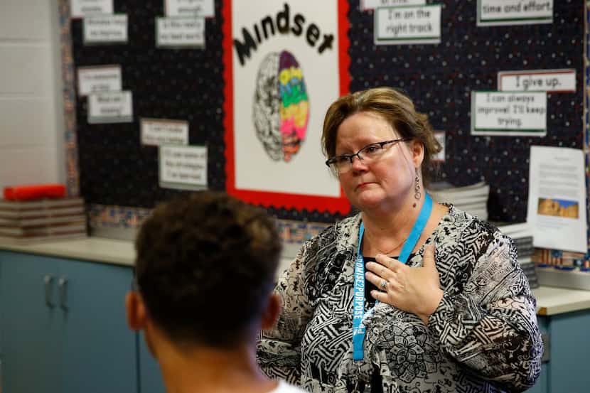 Eighth grade teacher, Joan Brandt listens as students share stories about what transpired...