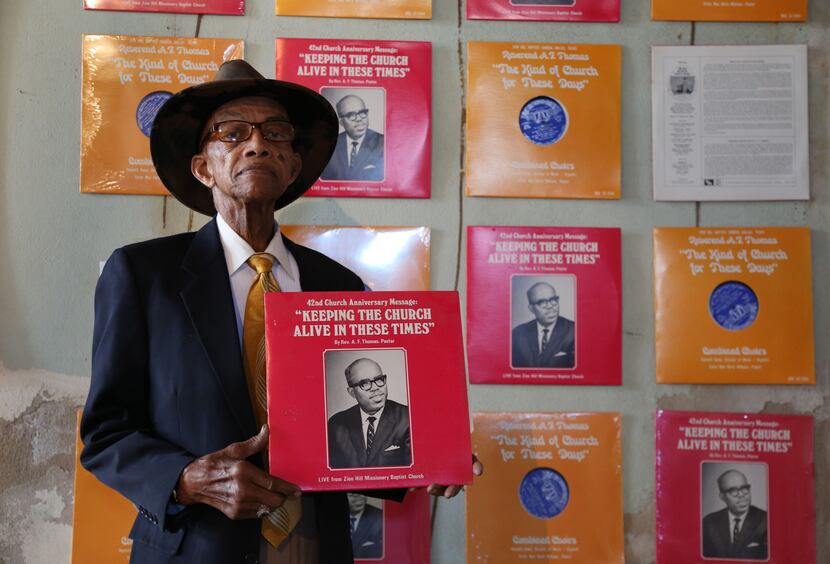 The Rev. James Whitaker holding a vinyl pressing of a gospel recording that was done live in...