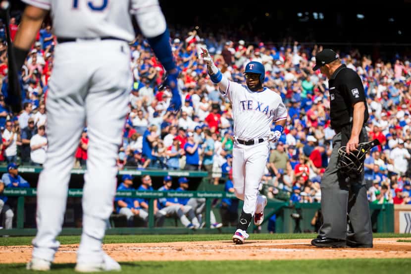 Texas Rangers shortstop Elvis Andrus (1) celebrates after a home run during the third inning...
