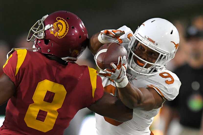 Texas wide receiver Collin Johnson, right, catches a pass as Southern California cornerback...