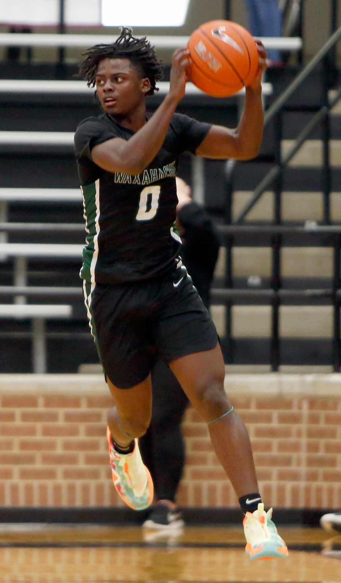 Waxahachie guard BJ Francis (0) leaps to pull down a long pass as he looks over the Coppell...