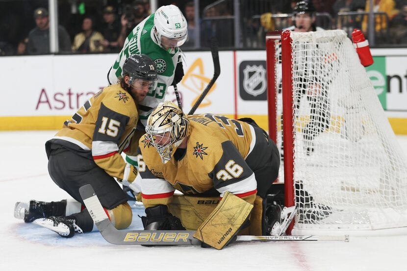 Vegas Golden Knights defenseman Noah Hanifin (15) collides into Dallas Stars center Wyatt...