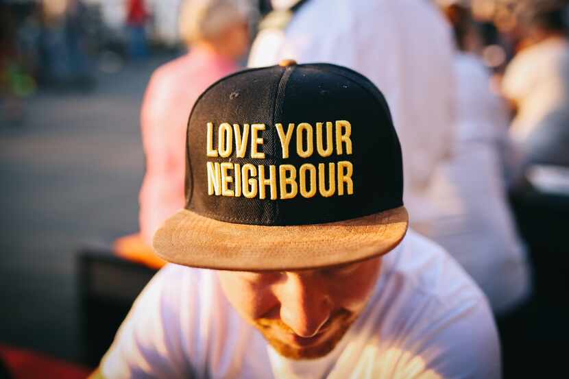 Man wearing a cap that reads "love your neighbor"