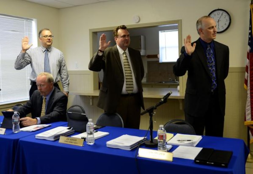 
Council members (from left) Steve Herrmann, Joe Burger and Mayor Lorne Megyesi stand to be...