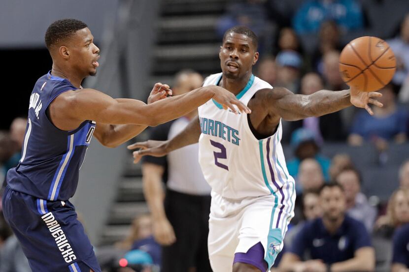 Dallas Mavericks' Dennis Smith Jr. (1) passes the ball past Charlotte Hornets' Marvin...
