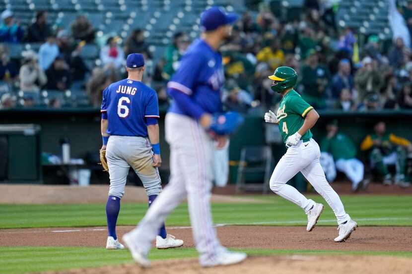 Oakland Athletics' Kevin Smith, right, runs the bases after hitting a solo home run against...