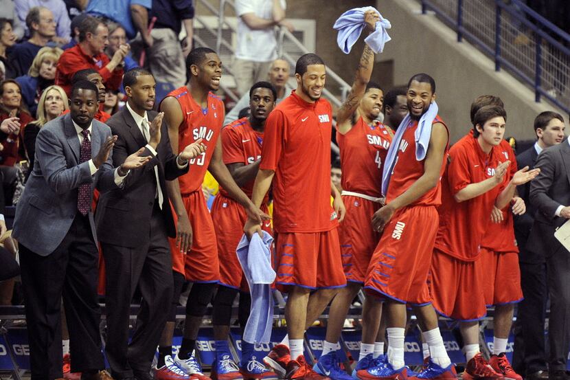 SMU assistant coach Ulric Maligi (far left) and players celebrate late in the second half of...