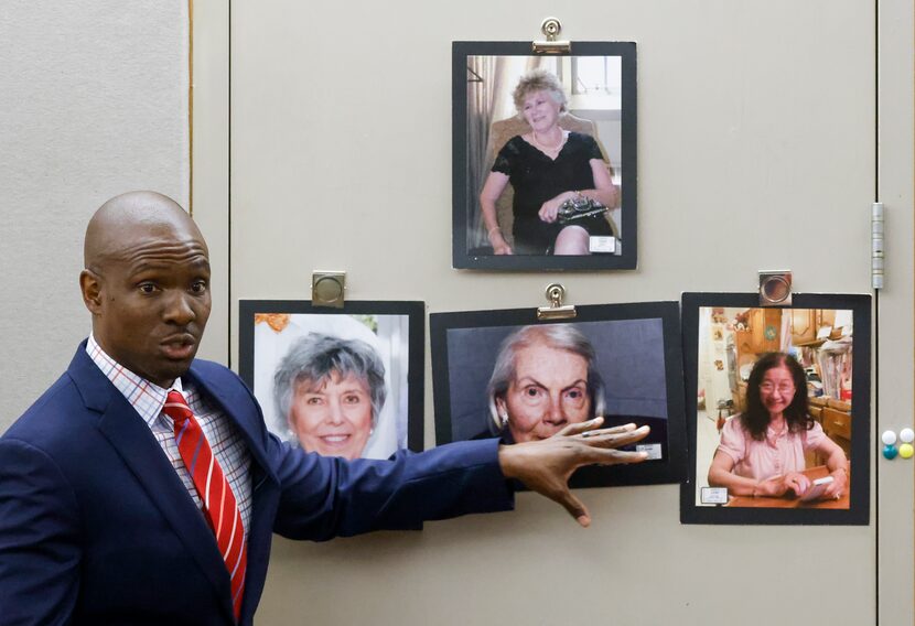 Defense lawyer Kobby Warren points toward photographs of the victims as he delivers his...