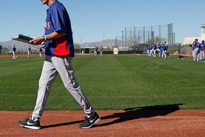 Texas pitching coach Mike Maddux keeps things running smoothly during Texas Rangers baseball...