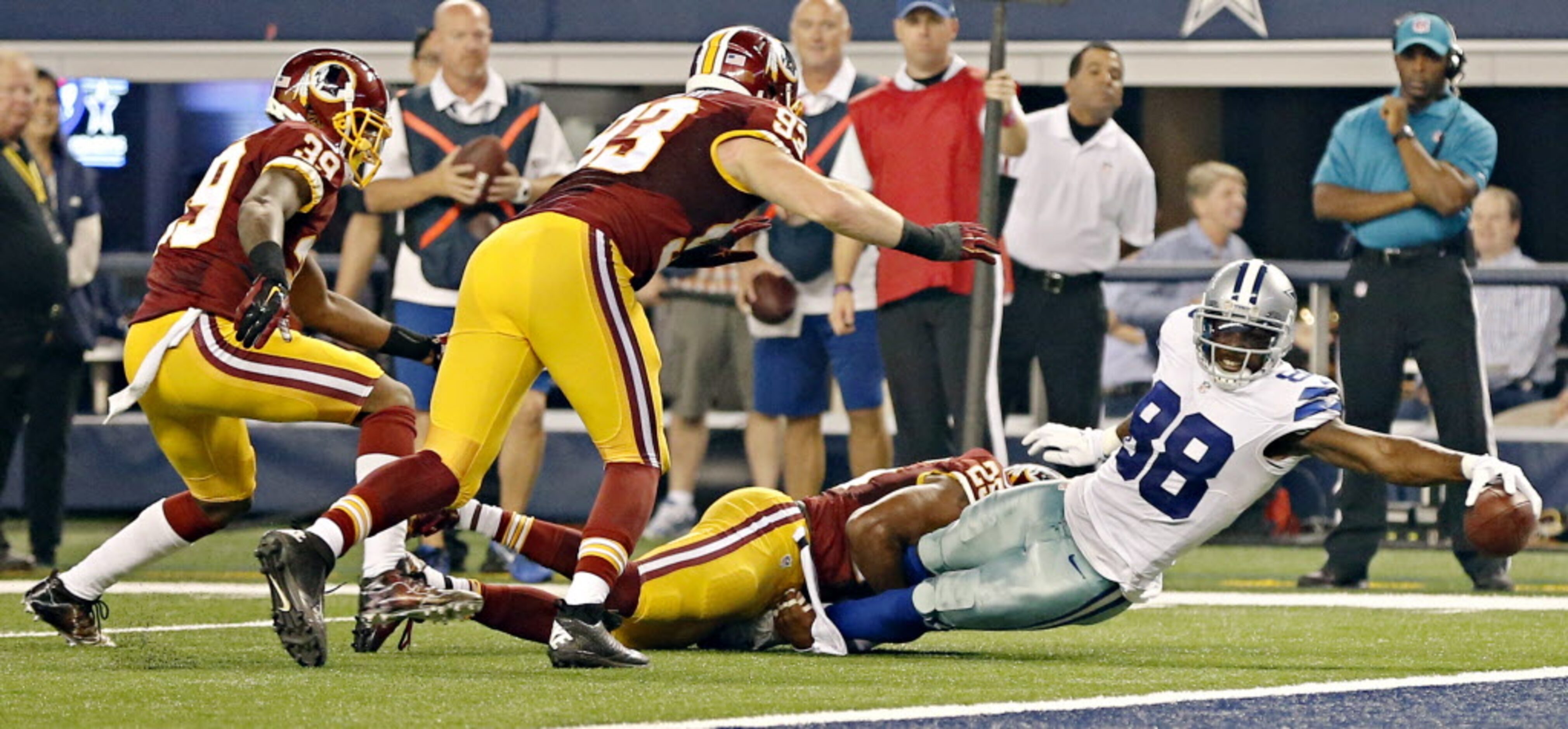 Dallas Cowboys wide receiver Dez Bryant (88) stretches away from a tackle by Washington...