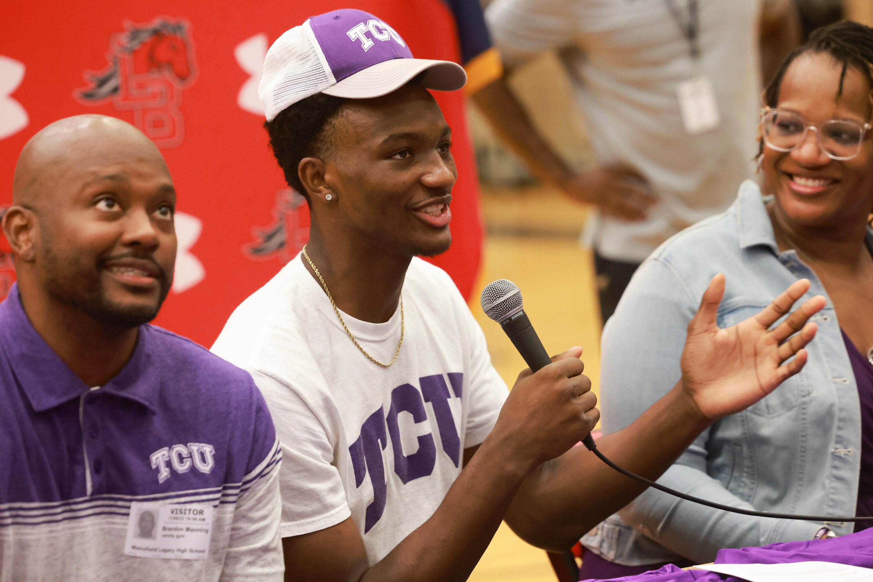 Isaiah Manning thanks his parents, sitting on each side of him, for their support as he’s...