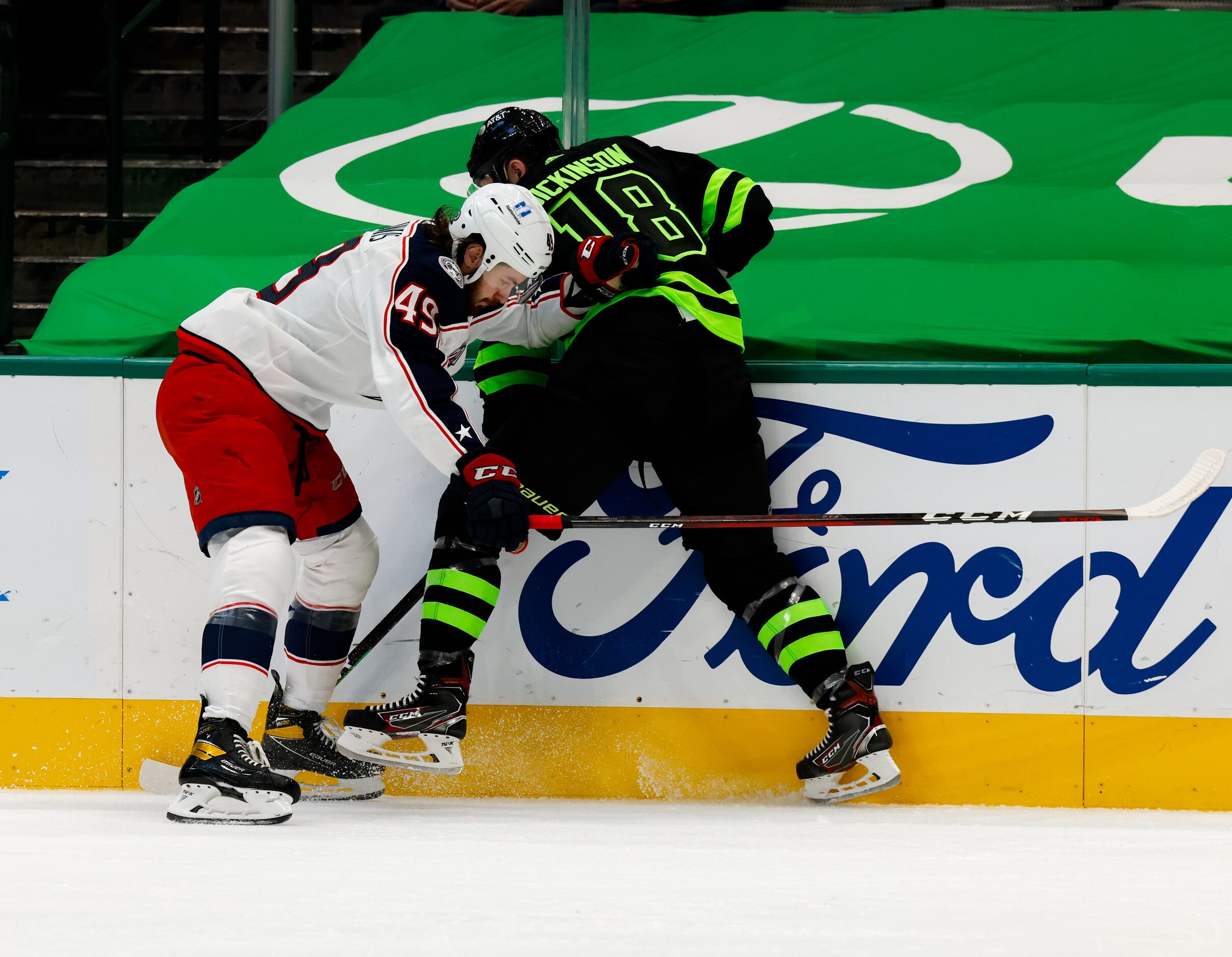 Dallas Stars center Jason Dickinson (18) and Columbus Blue Jackets center Ryan MacInnis (49)...