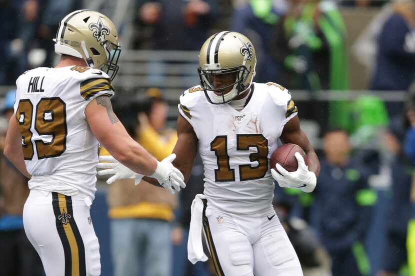 New Orleans Saints' Michael Thomas (13) is congratulated by Josh Hill on his touchdown...