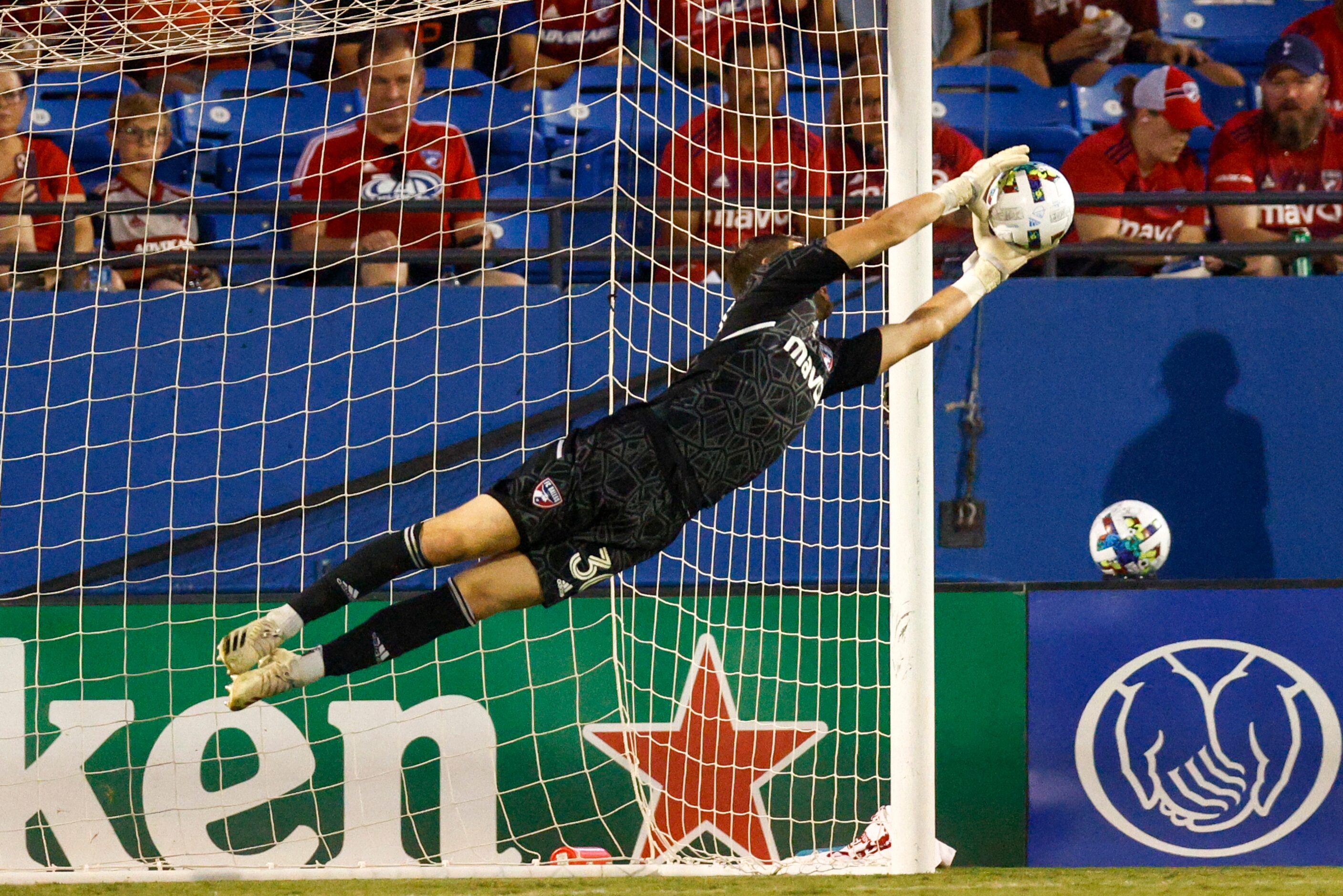 FC Dallas goalkeeper Maarten Paes (30) makes a leaping save during the first half of a match...