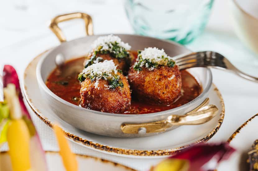 The arancini at 61 Osteria in Fort Worth is a blend of fontina cheese and rice, fried,...