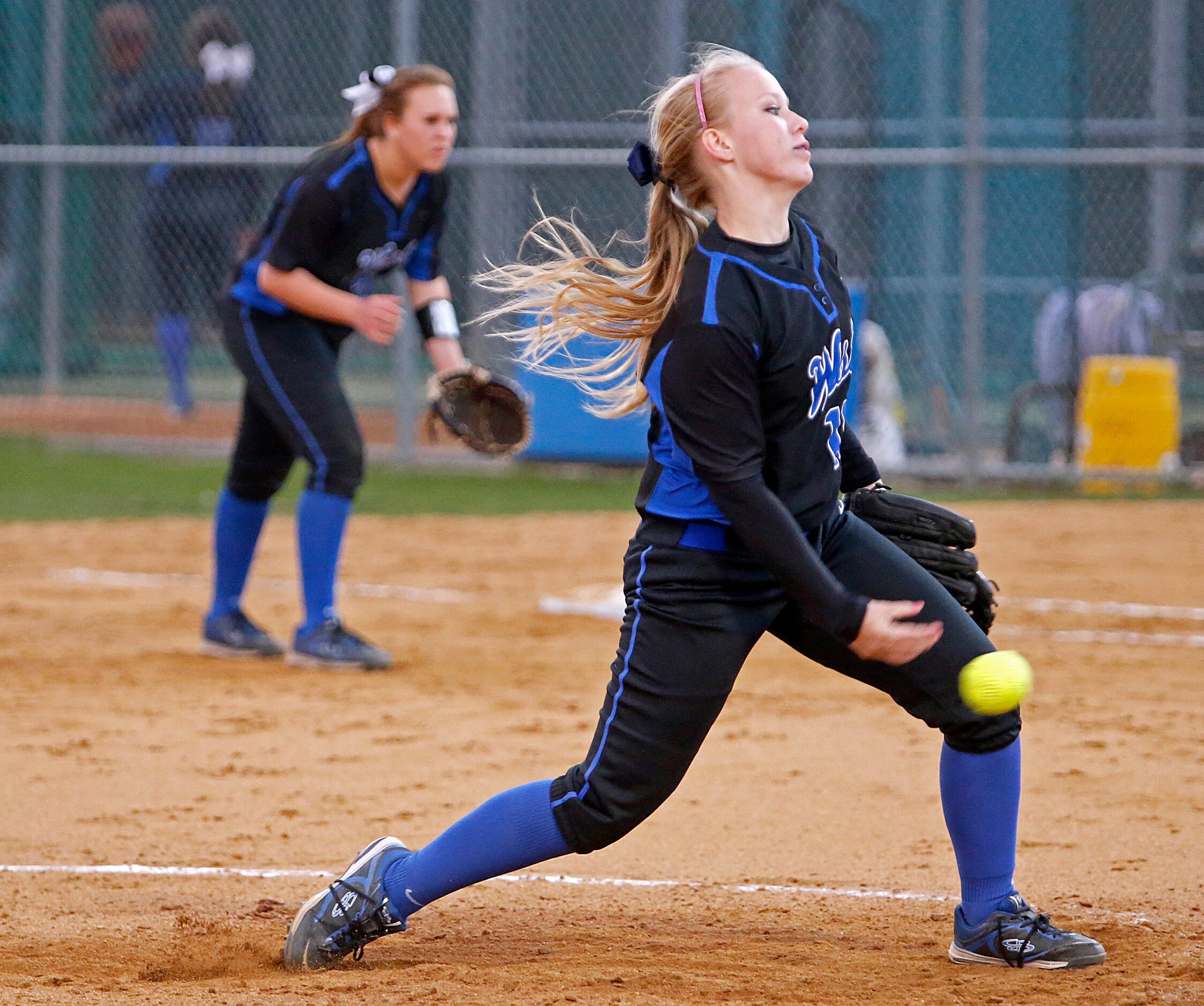 The Plano West High School varsity softball pitcher Marissa Butler (19) delivers a pitch...