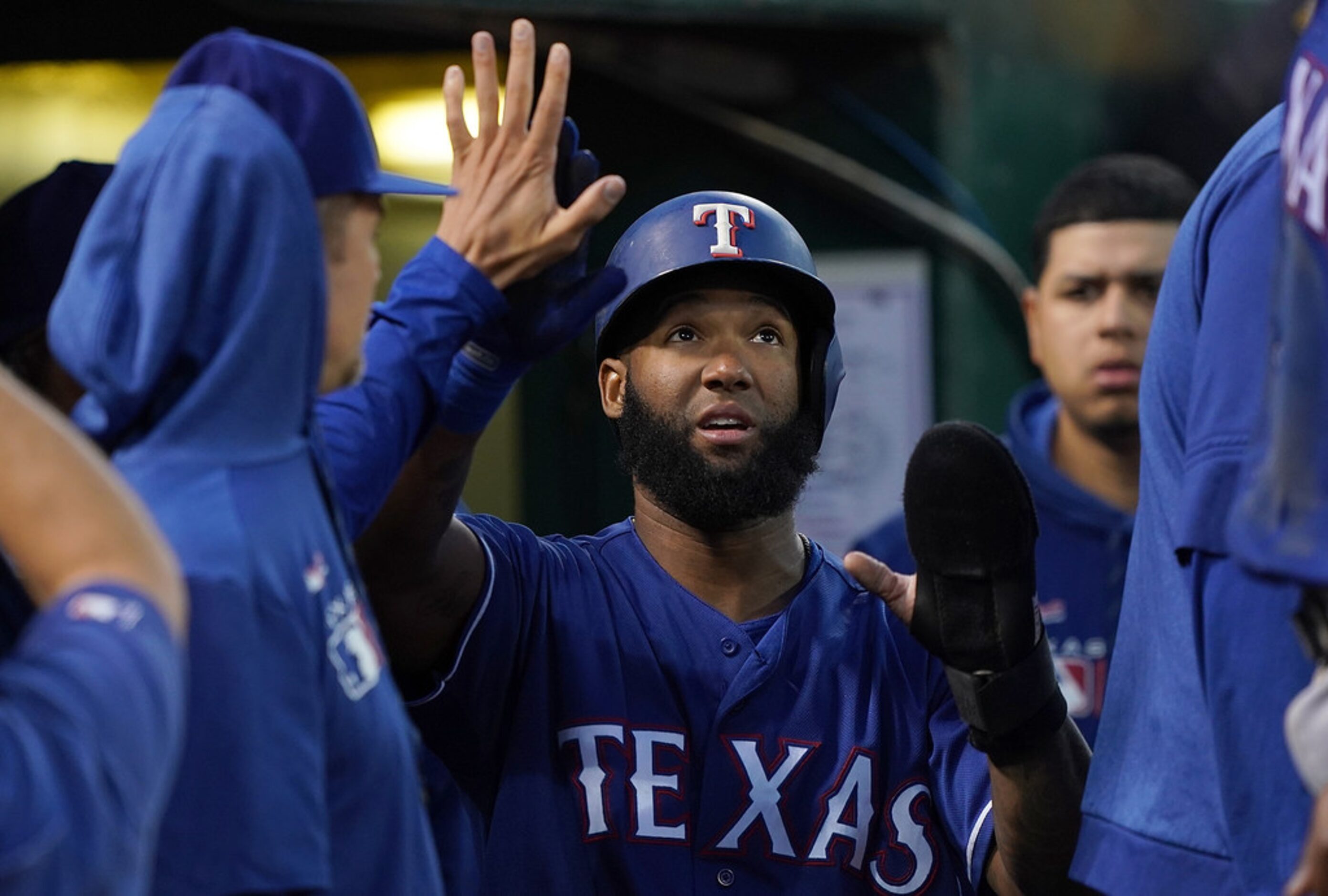 OAKLAND, CA - JULY 25:  Danny Santana #38 of the Texas Rangers is congratulated by teammates...