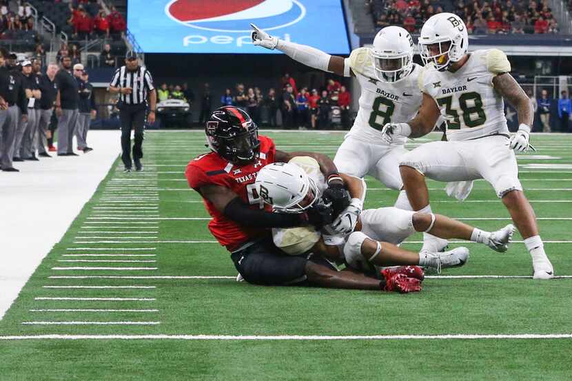 Baylor Bears cornerback Raleigh Texada (13) intercepts a pass intended for Texas Tech Red...