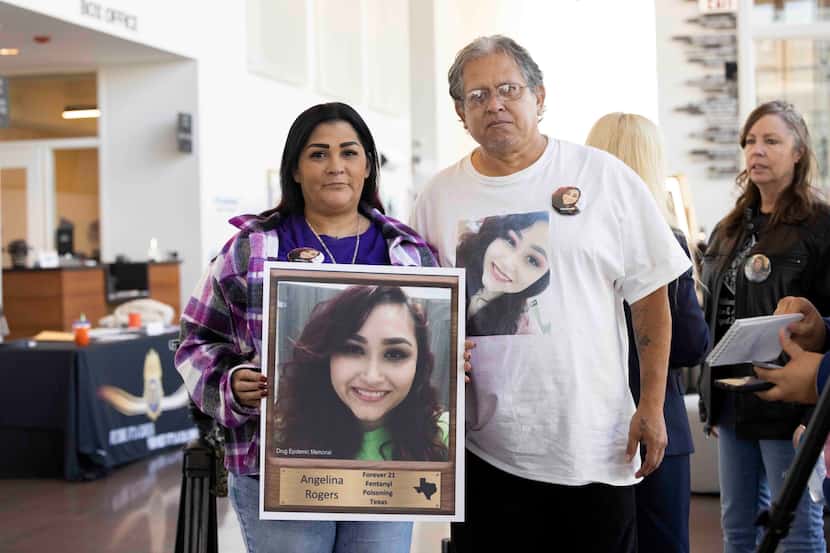 Christina Pena holds a photo of her late daughter Angelina Rogers while posing with husband...